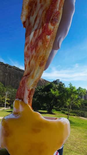 Hand Dips Pizza on Sauce  in a fake-out-of-home ad of Domino's Pizza