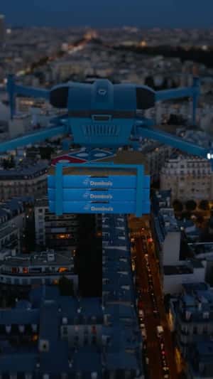 Drone Delivers Pizza at Stadium in a fake-put-of-home ad of Domino's Pizza