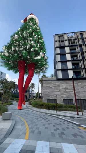 Woman Dressed with Christmas Tree in a fake-out-of-home ad of Elle Permanent