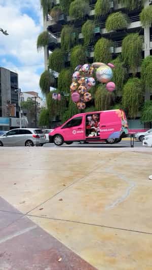 Van Lifted by Balloons in a fake-out-of-home ad of Enviaflores