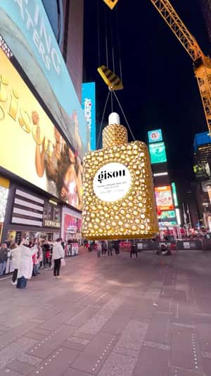 Hair Oil Bottle Lowered by Crane in a fake-out-of-home ad of Gisou