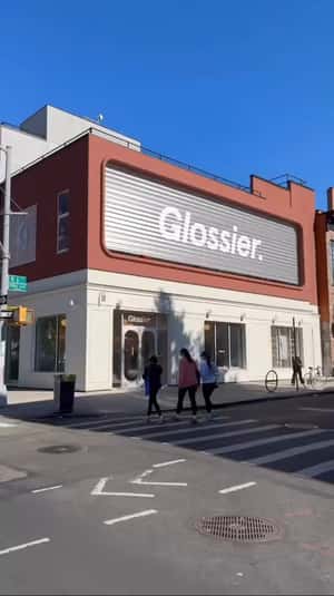 Lip Balm Fell from Store Facade in a fake-out-of-home ad of Glossier