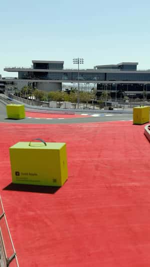Delivery Boxes Racing on Track in a fake-out-of-home ad of Gold Apple