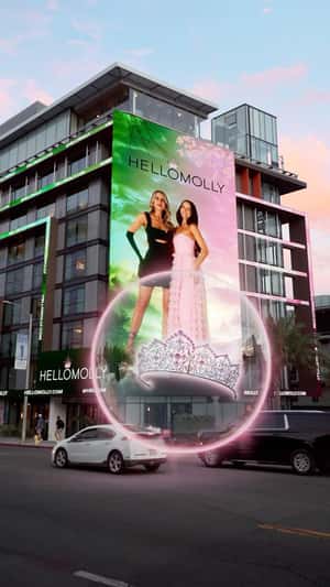 Model Throws Crown from Billboard in a fake-out-of-home ad of Hello Molly