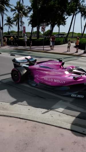 Cruising Pink-themed Formula-1 Car in a fake-out-of-home ad of Hello Molly