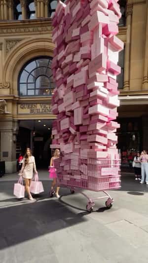 Overloaded Cart with Pink Boxes in a fake-out-of-home ad of Hello Molly
