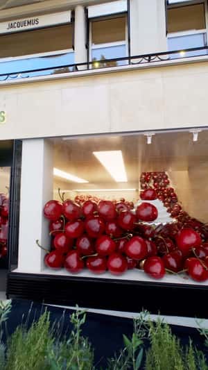 Cherries Overflow on Avenue Montaigne in fake-out-of-home ad of Jacquemus