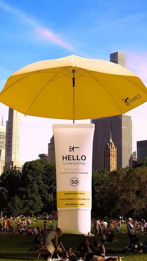 Umbrella Opens from Sunscreen Bottle in a fake-out-of-home ad of IT Cosmetics