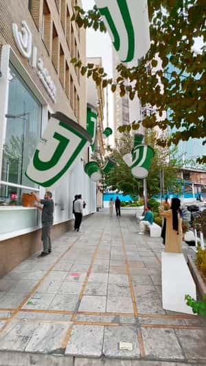 Coffee Cups Drops on the Street in a fake-out-of-home ad of J.Cafe