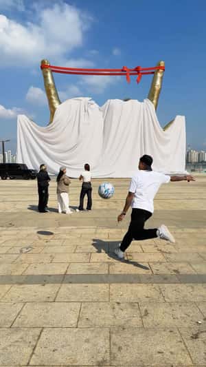 Golden Hand Gesture Sculpture in a fake-out-of-home ad of Jesse Lingard