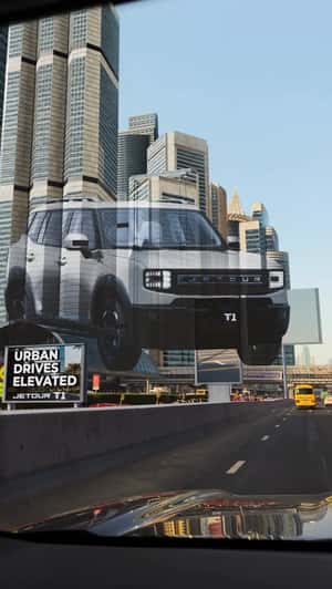SUV Projected on Skyscrapers in a fake-out-of-home ad of Jetour