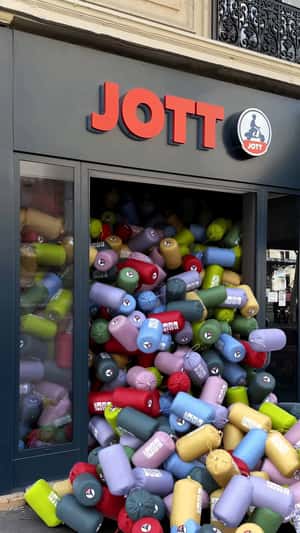 Puffer Jackets Spill Out from the Store in a fake-out-of-home ad of JOTT