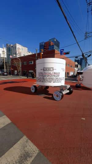 Facial Cream on Wheels Tips Over iin a fake-out-of-home ad of Kiehl's