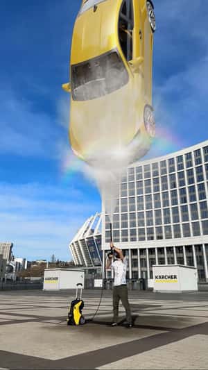 Car Lifted by Pressure Cleaner in a fake-out-of-home ad of Kärcher