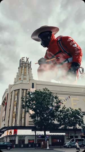 Climber Crafts Theater Tower in a fake-out-of-home ad of Le Grand Rex