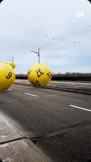 Numbered Balls Bounce on Street in a fake-out-of-home ad of Lotto