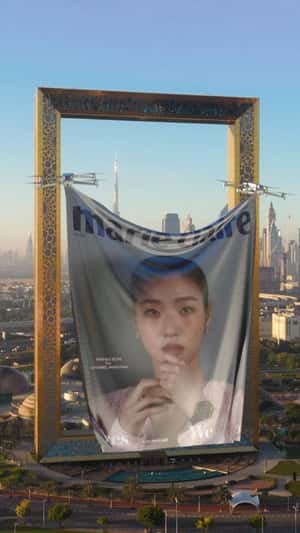 Drones Lift Magazine Cover Banner in a fake-out-of-home ad of Marie Claire