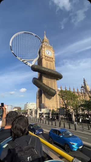 Tennis Racket Wraps Around Big Ben in a fake-out-of-home ad of Wimbledon