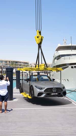 Crane Lifts Car Off Yacht in a fake-out-of-home ad of Mercedes-Benz Crane