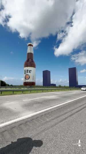 Beer Bottle Stands Beside Highway in a fake-out-of-home ad of Miller Lite