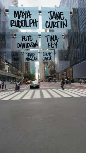 Name Banners Hang on Buildings in a fake-out-of-home ad of Saturday Night Live