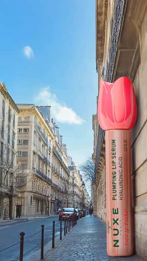 Giant Lip Serum on Paris Building Wall in a fake-out-of-home ad of Nuxe