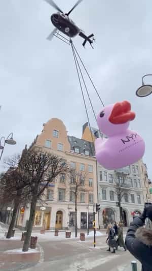 Giant Pink Duck Dropped at Stockholh Streets by Helicopter in a fake-out-of-home ad of NYX.