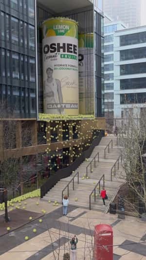 Billboard Reveals Giant Soda Can as Tennis Balls Spill in a fake-out-of-home ad of Oshee