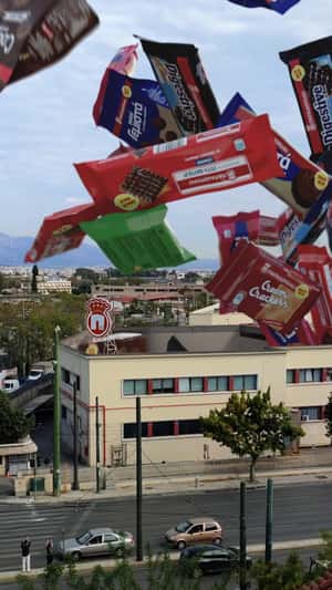 Giant Snacks Emerge from Factory Roof in a fake-out-of-home ad of Papadopoulos