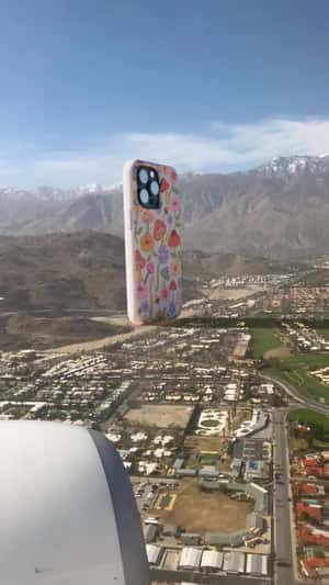 Giant Phone Drops Over Landscape in a fake-out-of-home ad of Pela Case