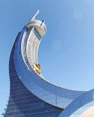 Porsche-Camel Hybrid Slides Down Katara Towers in a fake-out-of-home ad of Porsche