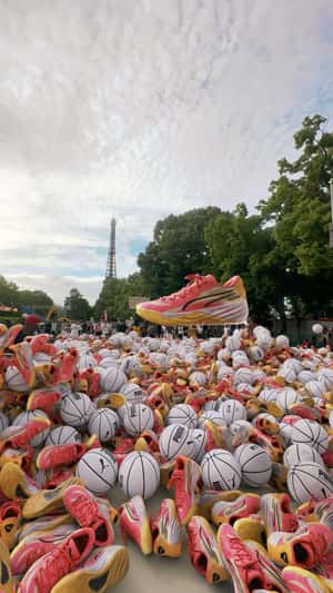 Sneakers and Basketballs Rain Over Eiffel Tower Court in a fake-out-of-home ad of Puma
