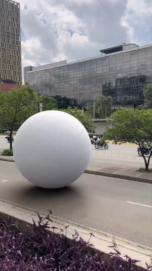 Giant White Sphere Rolls in a fake-out-of-home ad of Punto Blanco