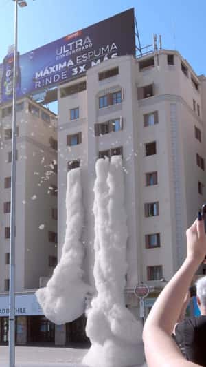 Foam Overflow from Building in a fake-out-of-home ad of Quix