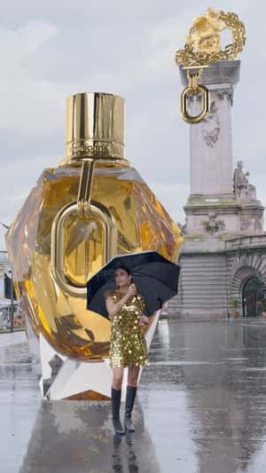 Giant Golden Perfume Unleashed at Place de la Concorde in a fake-out-of-home ad of Rabanne