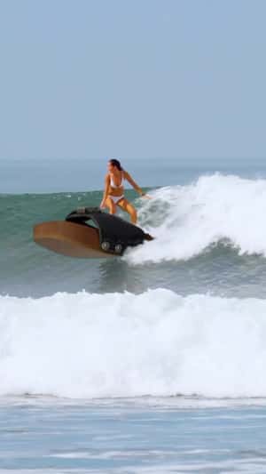 Woman Surfs on Giant Sandal in a fake-out-of-home ad of RE/DONE