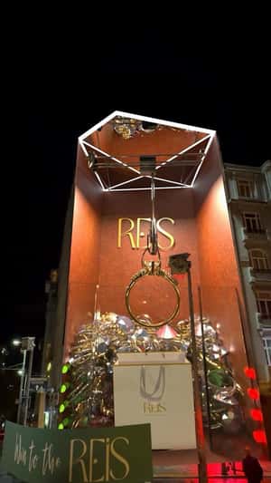 Giant Claw Machine Grabs Gold Ring in a fake-out-of-home ad of Reis