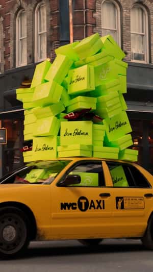 Boxes Stack on New York Taxi in a fake-out-of-home ad of Sam Edelman