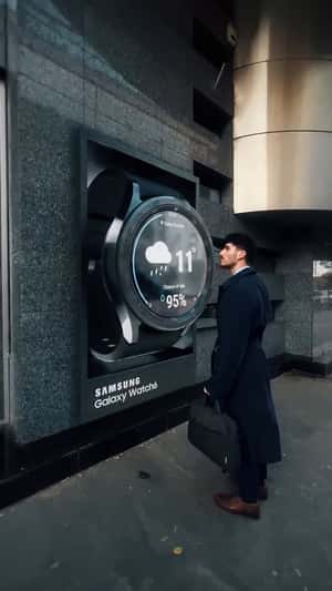 Massive Watch Swiped on Facade in a fake-out-of-home ad of Samsung