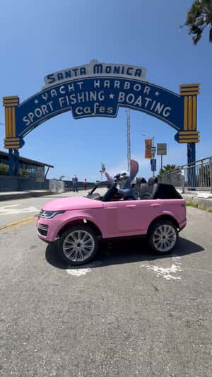 Stitch Drives Mini Pink Car in a fake-out-of-home ad of Santa Monica Pier