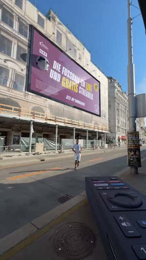 Footballs Burst from Billboard in Vienna in a fake-out-of-home ad of SimpliTV