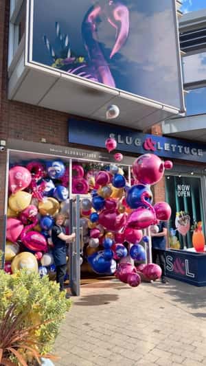 Doors Open Releasing Balloons in a fake-out-of-home ad of Slug & Lettuce