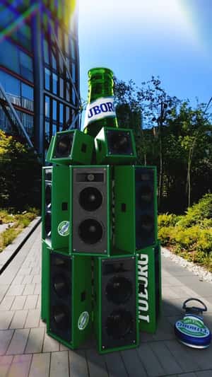 Giant Bottle with Speakers Pulsate Street in a fake-out-of-home ad of Tuborg
