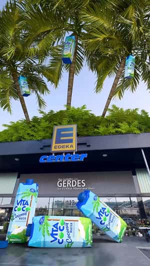 Giant Cartons Fall in EDEKA Storefront in a fake-out-of-home ad of Vita Coco