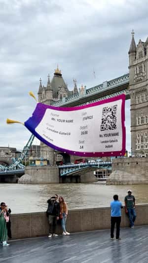 Giant Boarding Pass Flies Over Tower Bridge in a fake-out-of-home ad of Wizz Air