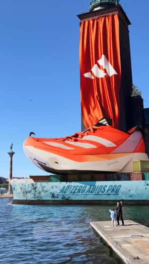 Giant Orange Shoe Floating In Stockholm in a fake-out-of-home ad of Adidas