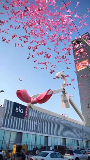 Giant Hanger Covered in Pink Bows in a fake-out-of-home ad of or lu sense