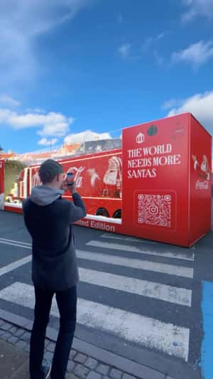 Giant Christmas Gift Box Reveals Red Truck in a fake-out-of-home ad of Coca-Cola