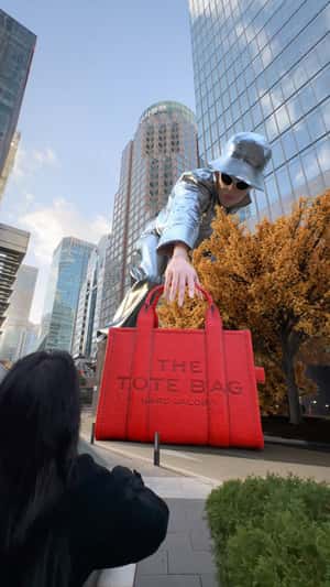 Giant Model Picks Up Red Tote Bag Marc Jacobs
