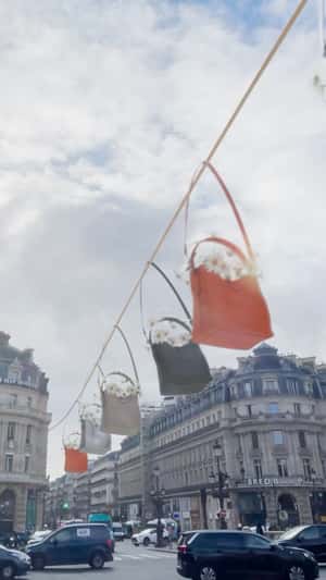 Longchamp Bags Gliding on Rope in fake-out-of-home ad of Longchamp